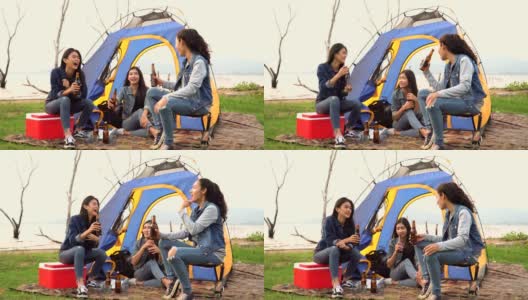 三个女人花周末时间露营和一起在日落的水边喝酒高清在线视频素材下载