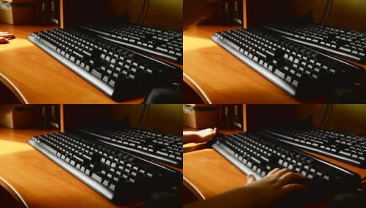 木桌上的黑色键盘特写，一个小孩子的手敲击键盘，在游戏的帮助下，孩子们早期掌握和学习电脑。高清在线视频素材下载