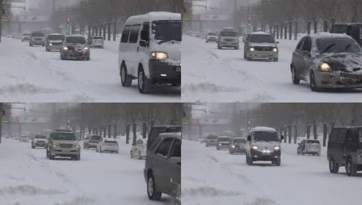 SlowMotion。降雪期间，汽车在海参崴的主要街道上行驶高清在线视频素材下载