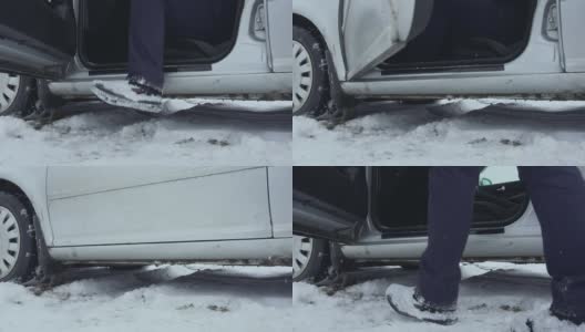 在冬天，司机没有把腿从雪地上挪开，就钻进了车里。又冷又坏的天气。白天庭院停车场的慢镜头。腿上覆盖着雪的人高清在线视频素材下载