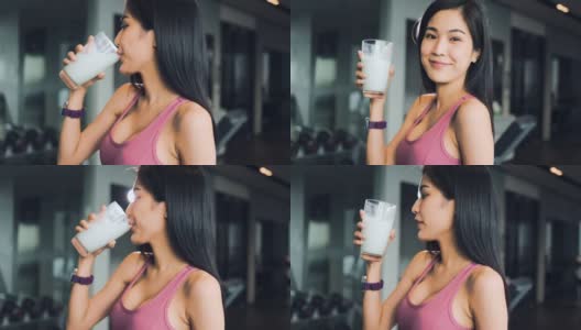 这位年轻美丽的亚洲女子在运动俱乐部的酒吧里喝奶昔。这位女士穿着运动胸罩，身材苗条。饮料是甜的，含有大量的蛋白质，对健康有好处。具有保健和美容理念的人。高清在线视频素材下载
