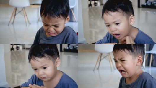 2岁亚洲男婴在室内哭泣。高清在线视频素材下载