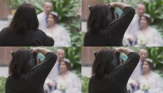 婚礼摄影师女人与相机拍照的新郎和新娘高清在线视频素材下载