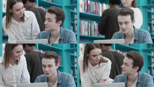 男大学生在图书馆用笔记本电脑做作业的特写。他的女朋友和他一起帮助和支持他高清在线视频素材下载