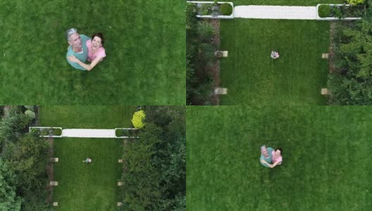 一对成熟的夫妇站在绿色的草坪上，对着镜头微笑着挥手高清在线视频素材下载