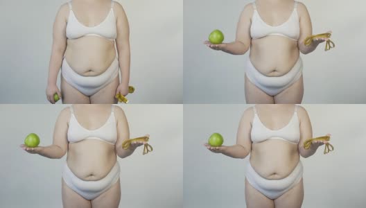 丰满的女性在镜头前展示苹果和胶带线，健康的生活方式，饮食高清在线视频素材下载