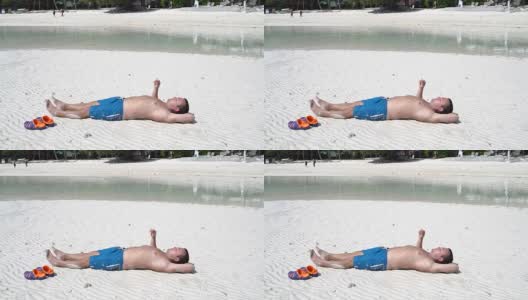 那个男人躺在海边的沙滩上抽烟高清在线视频素材下载