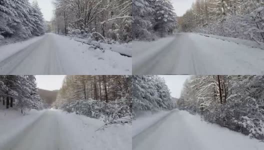 冬天，下雪了，在山路上开车。汽车个人透视的道路上有雪。高清在线视频素材下载