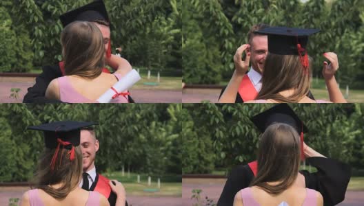 快乐的男学生拥抱姐姐，把他的毕业帽戴在她的头上高清在线视频素材下载