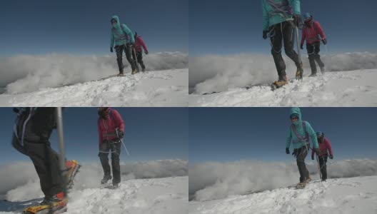 两名女登山家穿越云层上方的冰雪，以抵御寒冷。高清在线视频素材下载