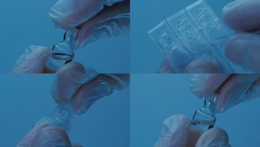手持医用手套，打开装有药品的小瓶，以蓝色为背景。宏高清在线视频素材下载