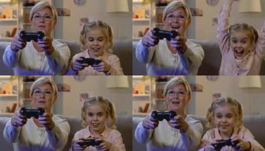 可爱的女孩和奶奶一起玩电子游戏，展示青春娱乐高清在线视频素材下载