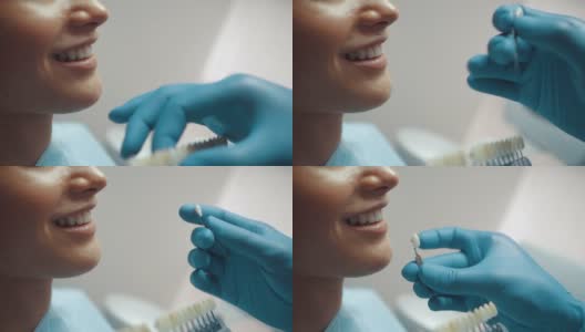 一位男性牙医用牙齿美白台为微笑的病人选择牙齿的颜色。牙科治疗和护理。口腔卫生。医疗保健理念。高清在线视频素材下载