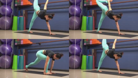 女孩锻炼通过平板瑜伽姿势进行锻炼。在瑜伽课上锻炼身体。高清在线视频素材下载