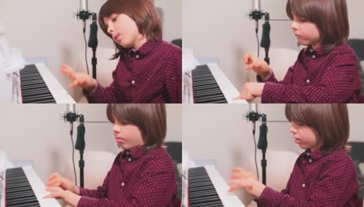 少年在音乐课上富有表现力地按钢琴键天才儿童高清在线视频素材下载
