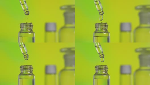透明的油滴从玻璃瓶中的吸管中落下高清在线视频素材下载