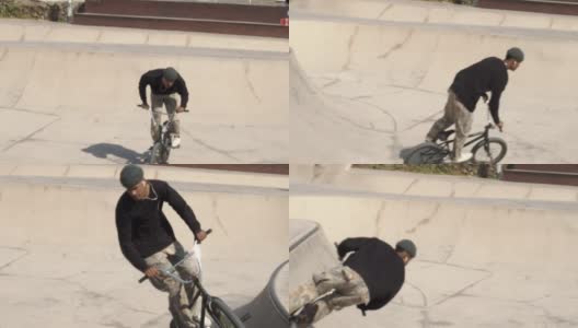 一个年轻的黑人男子在滑板公园与小轮车跳跃的慢动作。城市运动高清在线视频素材下载