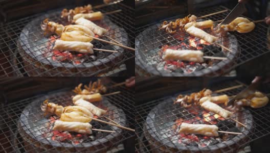 特写的烤鱿鱼串上的街头食物高清在线视频素材下载