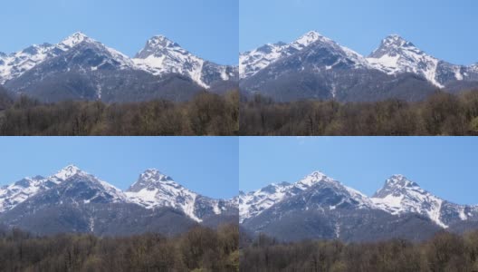 在阳光明媚的日子里，俄罗斯索契的红波利亚纳，白雪皑皑的山脉和蓝天上的白云，风景如画高清在线视频素材下载