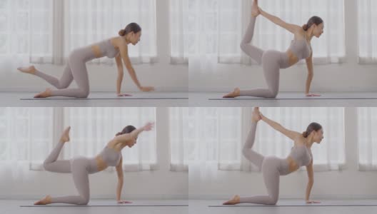 快乐运动的亚洲女性练习瑜伽伸展姿势，伸展肌肉，用冥想的微笑来热身，健康的女性在家里做瑜伽锻炼和放松，瑜伽保健概念高清在线视频素材下载