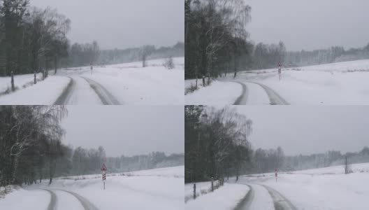 冬季暴风雪雪道，森林路面危险，行驶在冬季道路上高清在线视频素材下载