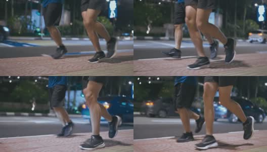 近距离低角度亚洲华人活跃的老人和他的儿子在晚上下班后一起在城市跑步慢跑高清在线视频素材下载