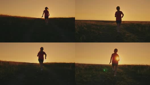 无忧无虑的女孩跑上了山在夕阳的背景。克服困难，首先取得成就高清在线视频素材下载