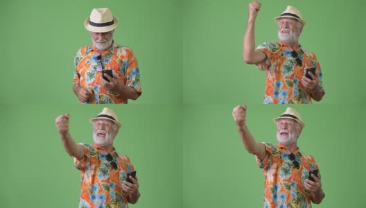 英俊的年长留胡子的游客男子准备假期的绿色背景高清在线视频素材下载