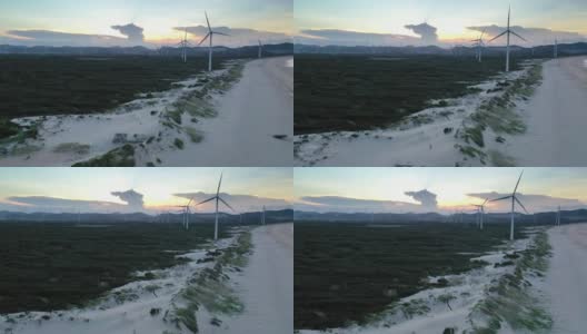 从无人机的角度看日落时海滩上的风力发电场高清在线视频素材下载