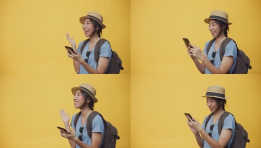 快乐青春美丽亚洲女人戴着帽子和背包持有智能手机享受预订旅行旅行酒店和机票书。高清在线视频素材下载