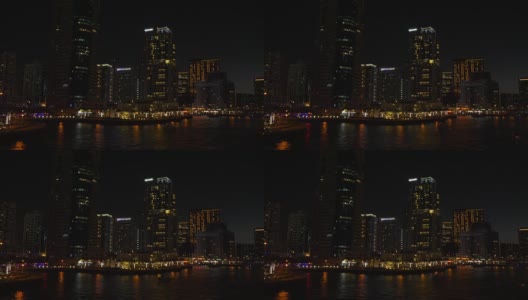 全景从长廊上的夜城和摩天大楼在迪拜码头高清在线视频素材下载