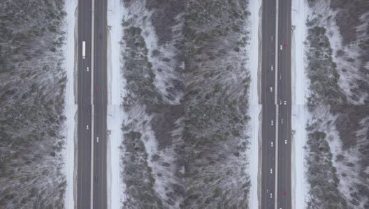 冬季高速公路上的俯视图汽车交通。汽车和卡车在冬天的路上行驶高清在线视频素材下载