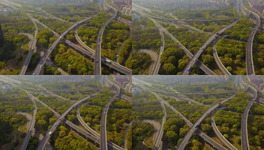 公路路口的汽车鸟瞰图，绿树环绕。桥梁、道路或街道在建筑结构和交通概念上。前视图。城市城市，中午，中国上海。高清在线视频素材下载