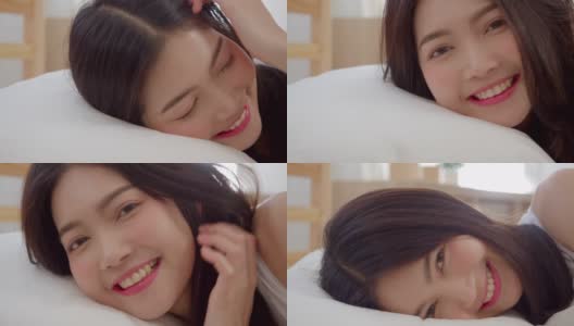 亚洲女人微笑躺在床上的卧室，美丽的日本女性使用放松时间后，在家里醒来。生活方式女性在家里使用放松时间的概念。慢动作镜头。高清在线视频素材下载
