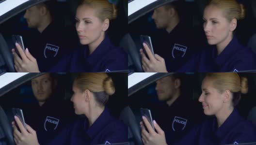 警察坐在车里用手机监控紧急呼叫高清在线视频素材下载