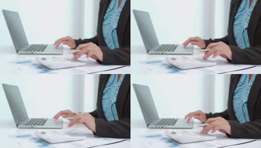 在办公室用笔记本电脑使用计算器处理财务和会计数据的4K视频片段高清在线视频素材下载