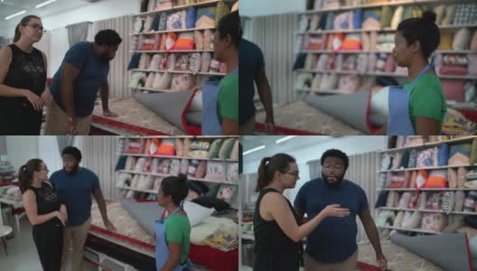 在家具店帮一对夫妇买地毯的女售货员高清在线视频素材下载