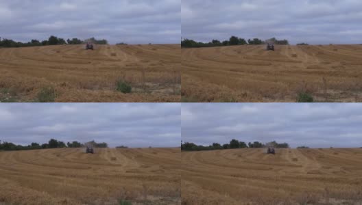 远处农民用拖拉机在田里耕作高清在线视频素材下载