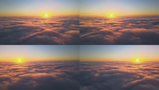 从高空俯瞰，浓密蓬松的积云在傍晚飞舞。从飞机窗口看到的令人惊叹的日落高清在线视频素材下载