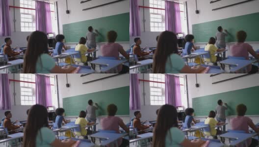 老师在学校上课时与学生交谈——使用口罩高清在线视频素材下载