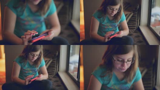 小女孩在玩手机游戏。高清在线视频素材下载
