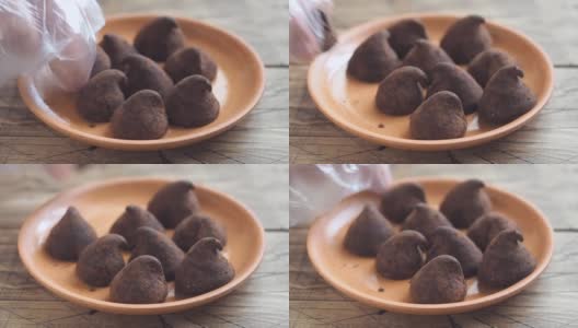 手工制作的松露巧克力糖果铺在盘子上。高清在线视频素材下载