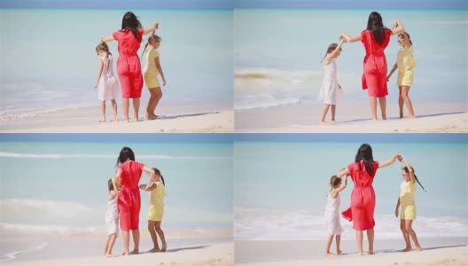 美丽的妈妈和她可爱的小女儿在海滩上高清在线视频素材下载