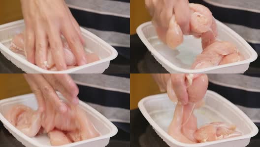 用手把生鸡肉放在厨房台面的塑料托盘里腌制高清在线视频素材下载