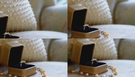 结婚戒指和珍珠项链在扶手椅上4K 4K高清在线视频素材下载