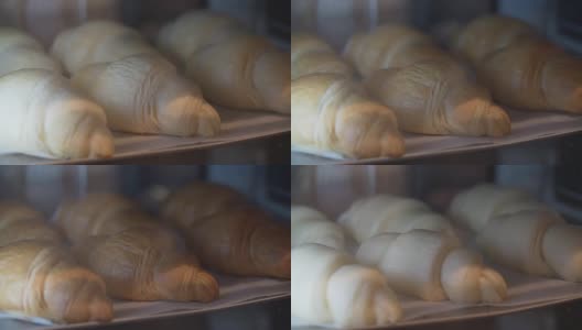 牛角面包在烤箱中烘烤和发酵的时间流逝视频。高清在线视频素材下载