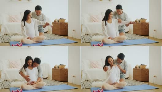 丈夫给怀孕的妻子背部和肩部按摩后，在家训练瑜伽或锻炼，健康和怀孕的概念高清在线视频素材下载