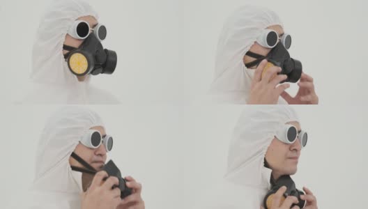 特写的人在防护服脱下防毒面具从自己。在白色背景上拍摄。高清在线视频素材下载