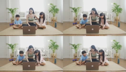 亚洲母亲和孩子在COVID-19大流行期间在家锻炼。高清在线视频素材下载
