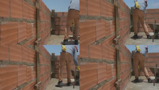 建筑工人在粉刷砖墙高清在线视频素材下载